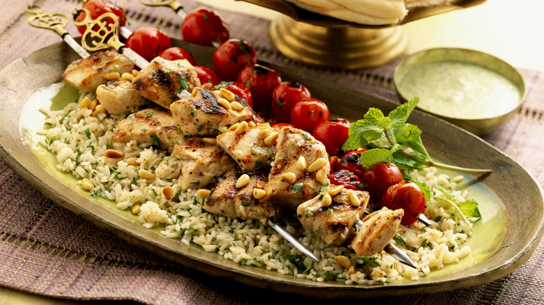 plate of kebabs, tomatoes, and rice