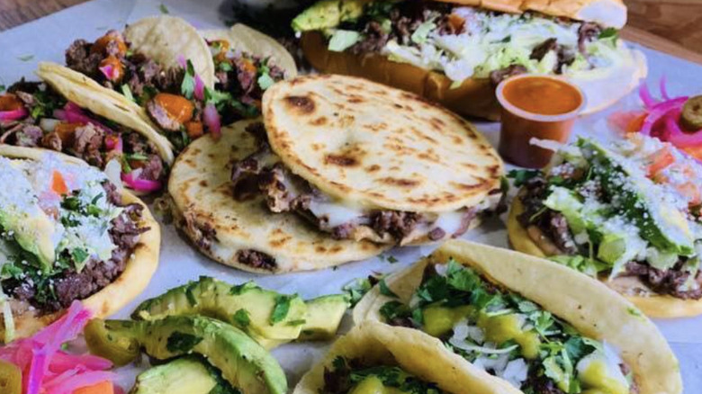 Various types of Mexican street food, including tacos, sopes, gorditas, and a pambazo, from Tacos El Bigotes
