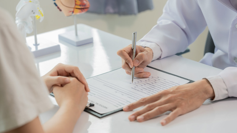 a health worker writing on a board