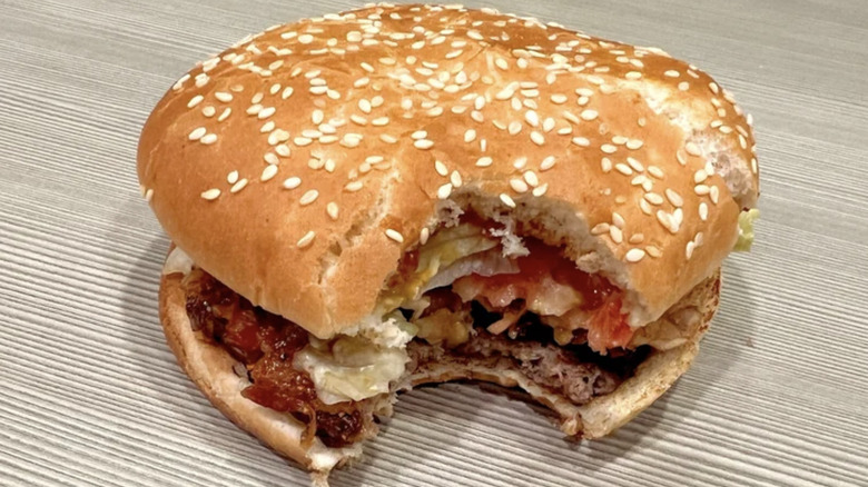 Burger King Candied Bacon Whopper with bite taken out of it