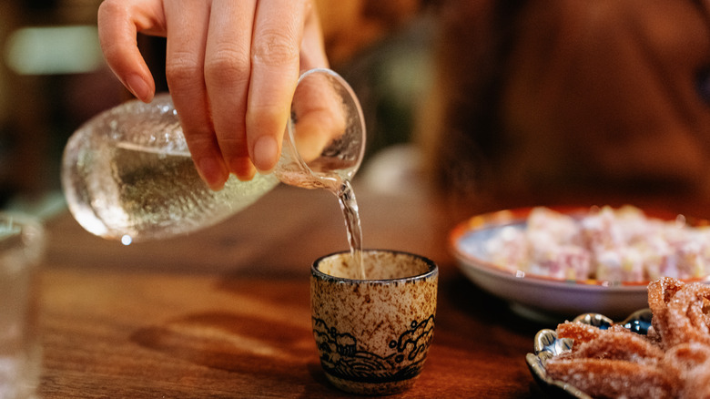 sake being poured at restaurant table