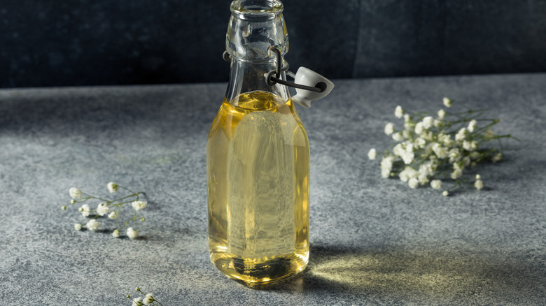 Elderflower simple syrup in a glass bottle.