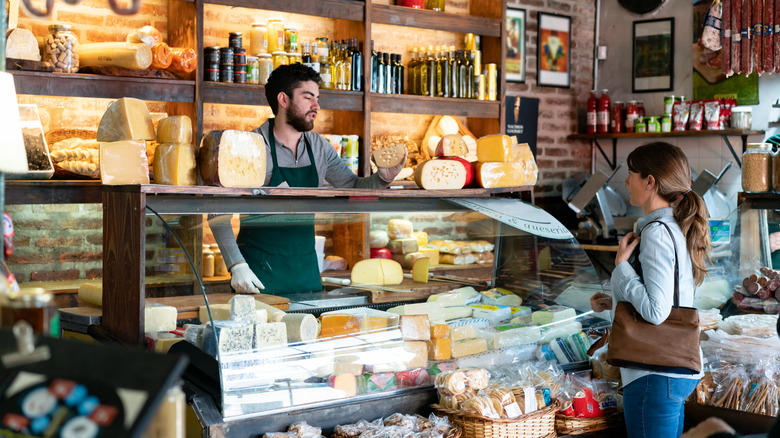 Worker at deli helping customer