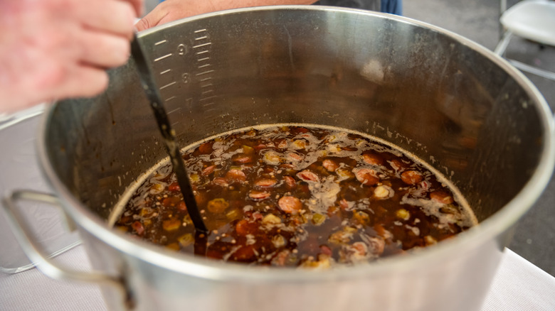 Stirring a pot of gumbo.