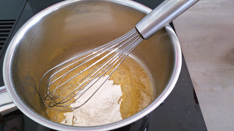 Whisking the roux in a pan