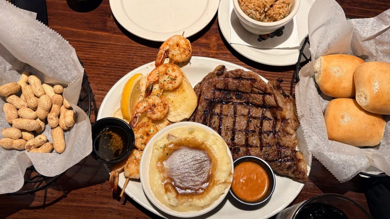 A spread including a large steak served at Texas Roadhouse