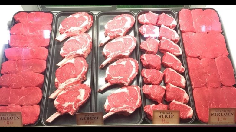 Steak display case at Texas Roadhouse filled with raw steak
