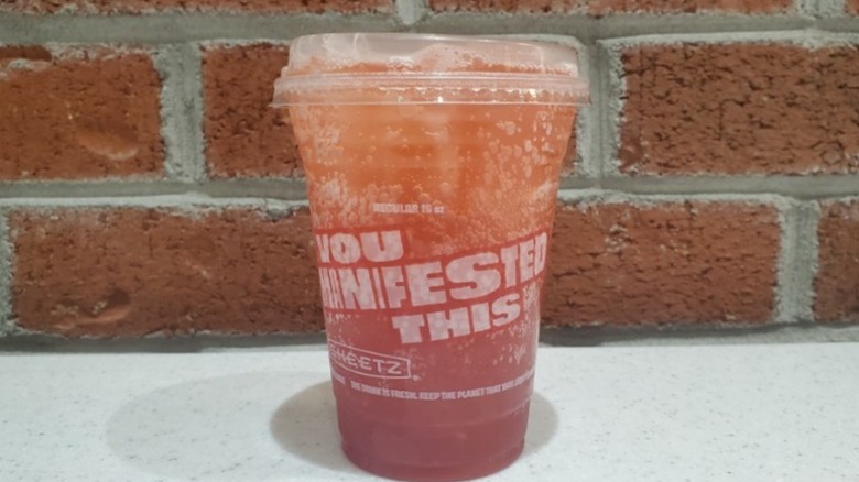 Strawberry Refresher with Mango Bubbles from Sheetz with brick wall background