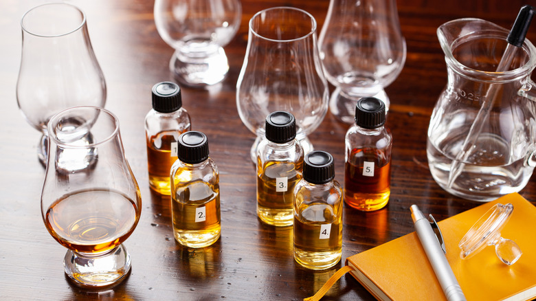 Numbered bottles of whiskey with glasses on the side