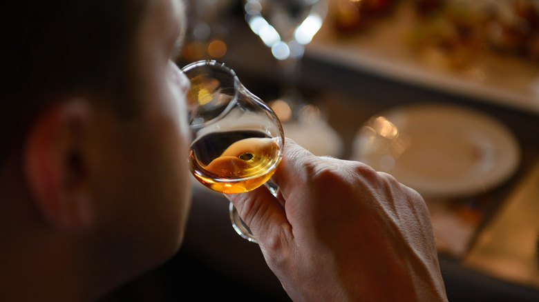 Person tasting whiskey