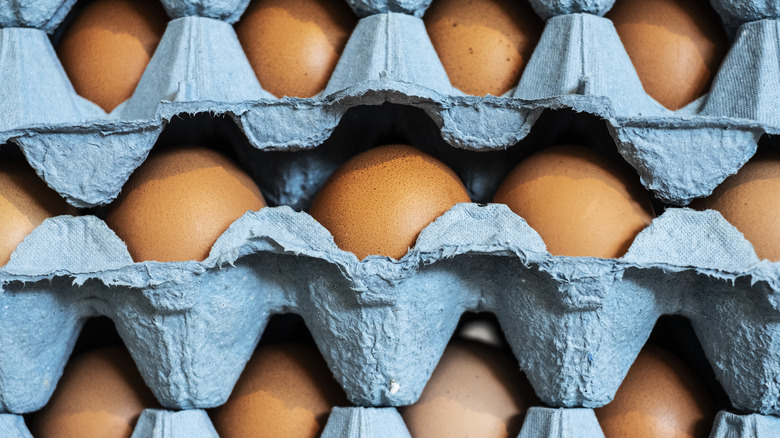 Brown eggs in stacked cartons