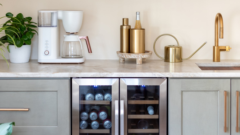 Home bar with sink, coffee maker, and in-cupboard cooler.