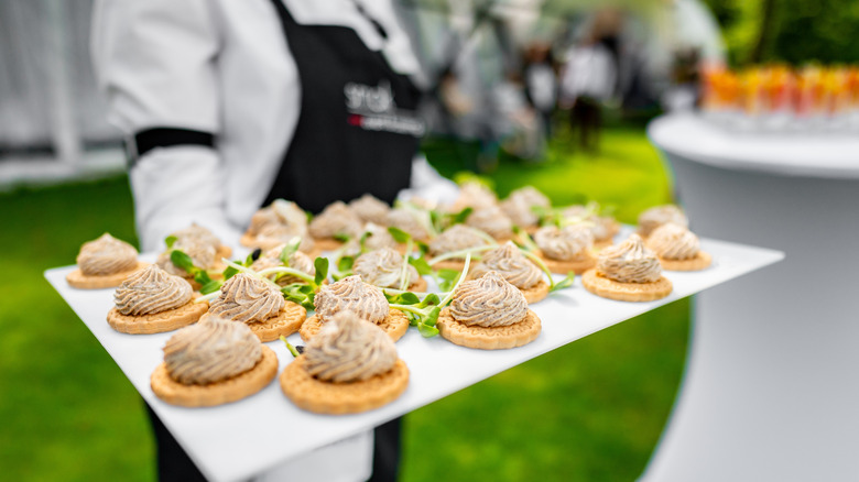Server with hors d'oeuvres at a wedding.