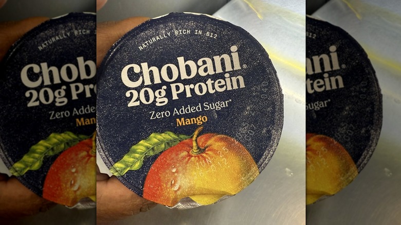 Hand holding Chobani zero added sugar yogurt