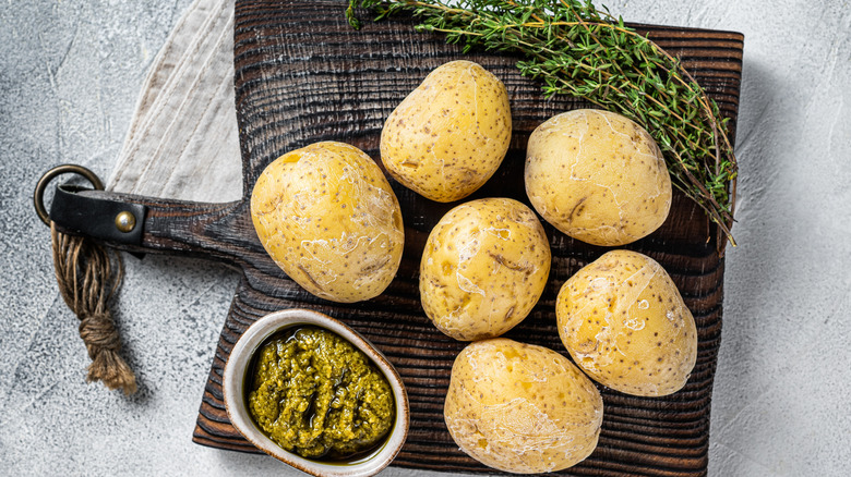 Wrinkly potatoes with sauce on a table.