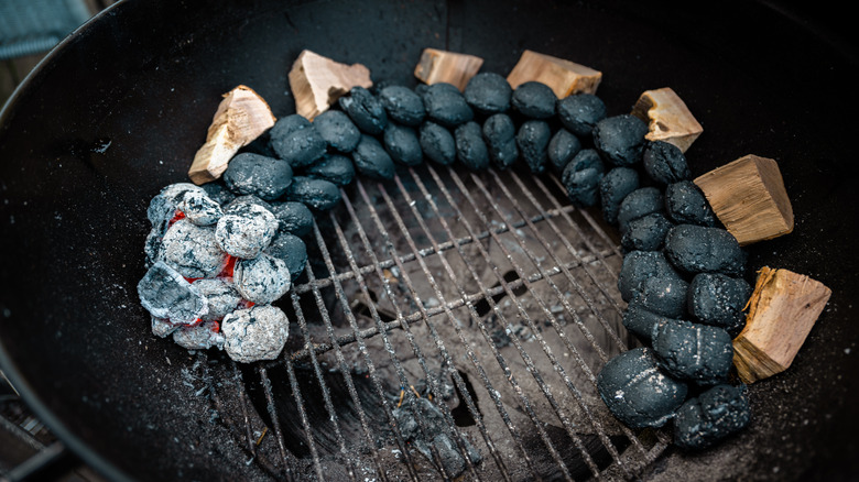 A grill lined with briquettes using the snake method