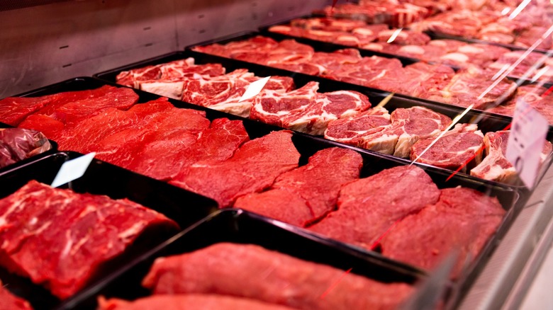 Trays of steaks on display in a store