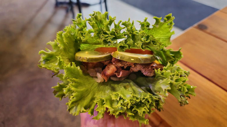 burger held in lettuce leaves as a wrap