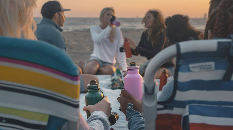 People using the BottleKeeper Standard 2.0 on the beach