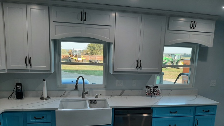 Two kitchen windows with arched wooden valances.