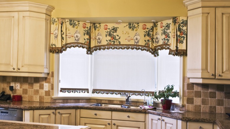 Triple-pane kitchen window with patterned valance.