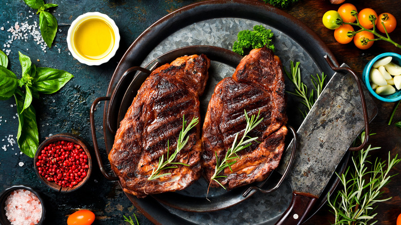 Grilled ribeye steaks with herbs