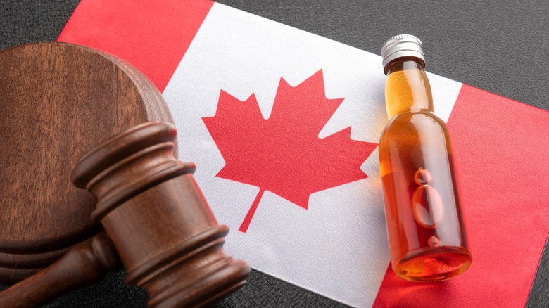 Canadian flag with whisky bottle and gavel.
