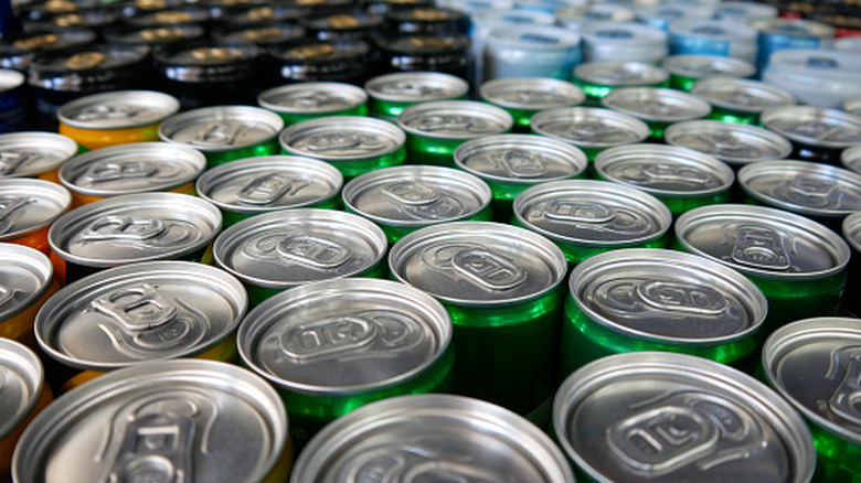 A collection of different colored cans, focusing on the pull-tab lids.