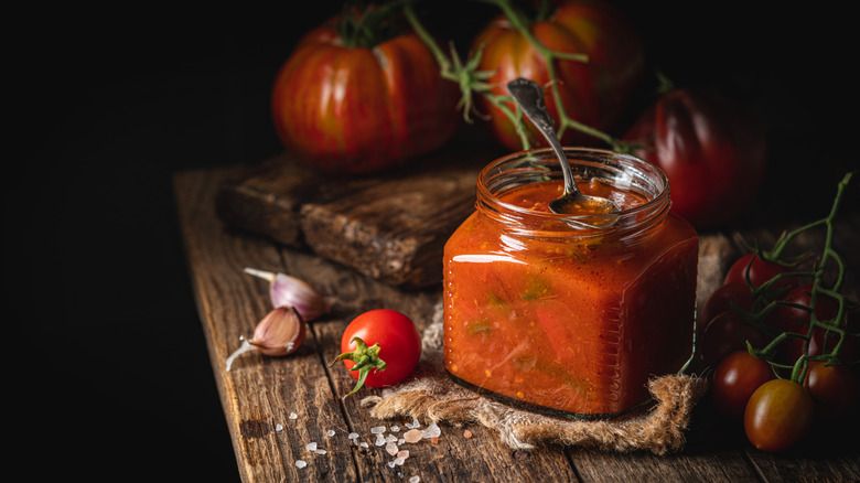 Jarred salsa on wooden board