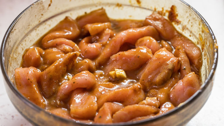 Pork marinating in a bowl