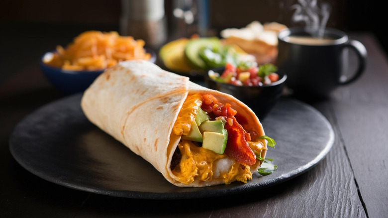 Breakfast burrito on black plate