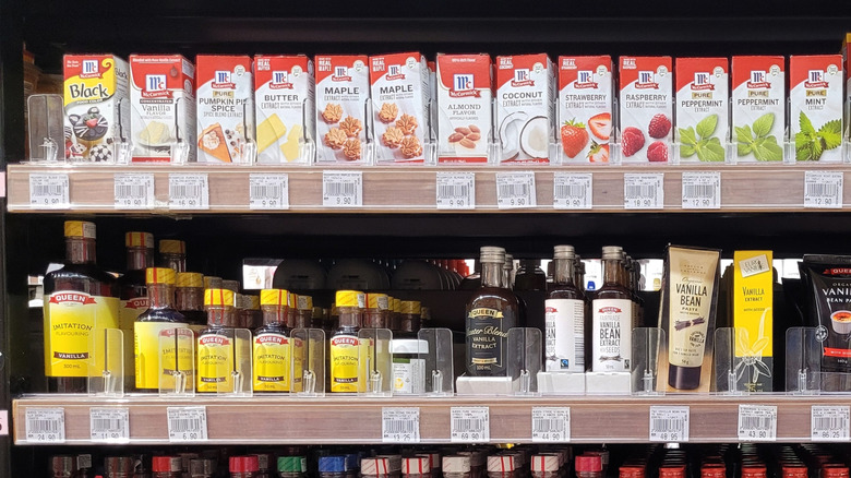 Grocery store baking aisle shelf containing extracts, including butter