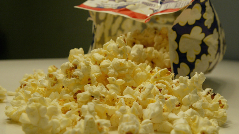 Bag of microwave butter popcorn spilled onto a table