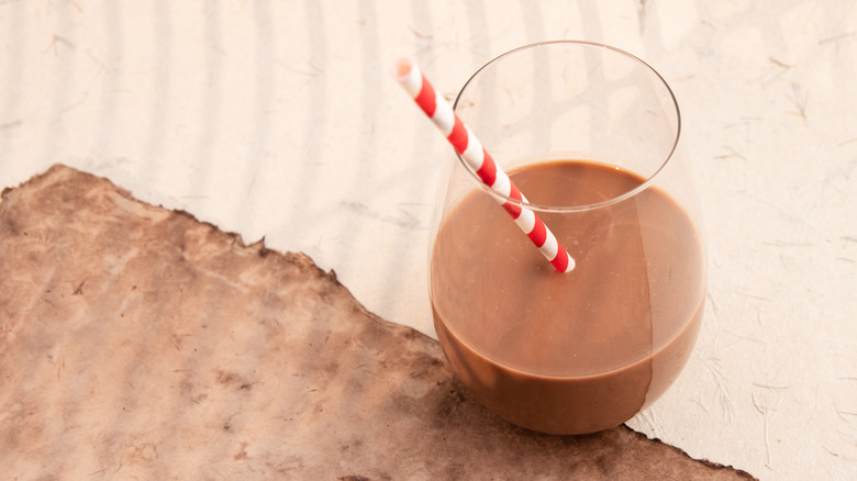 Drinking chocolate in a glass with a straw