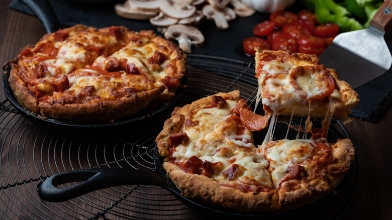 individual deep dish pizzas in cast iron pans