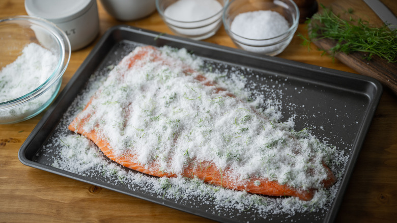 A salmon filet covered in salt