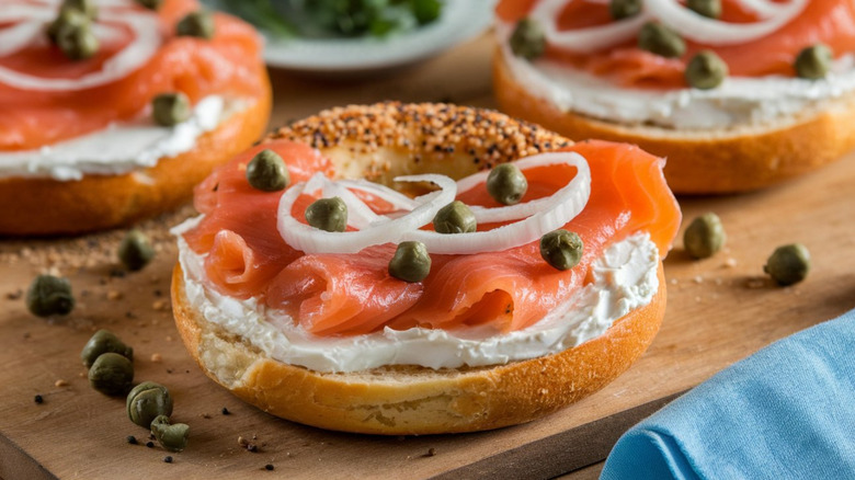 Bagels topped with lox, cream cheese, onions, and capers.