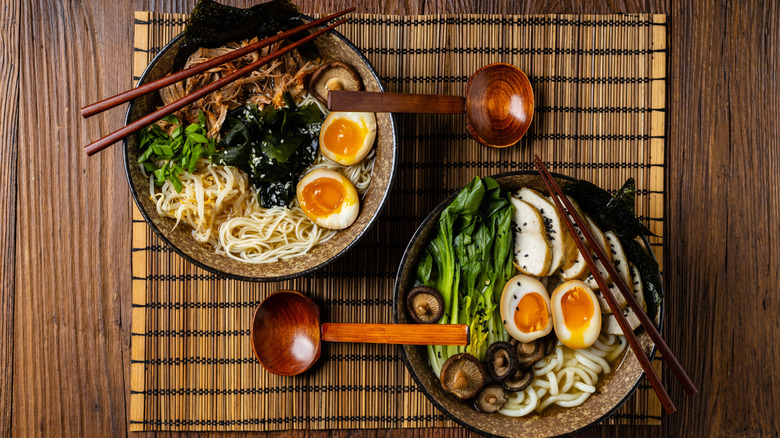bowl of ramen noodles (L) and udon noodles (R) from above
