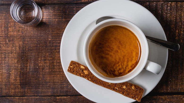 A cup of espresso with biscotti