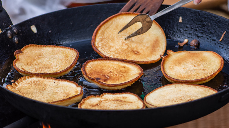 Russian buckwheat cakes cooking in a pan