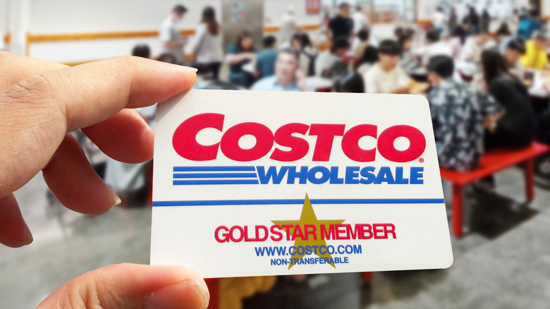 Person holding a Costco wholesale Gold Star membership card