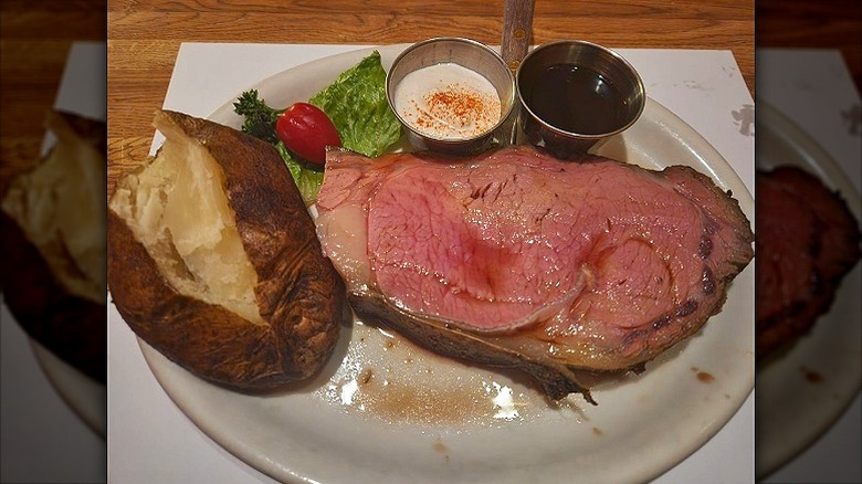 Prime Rib with baked potato and au jus at Club Paris