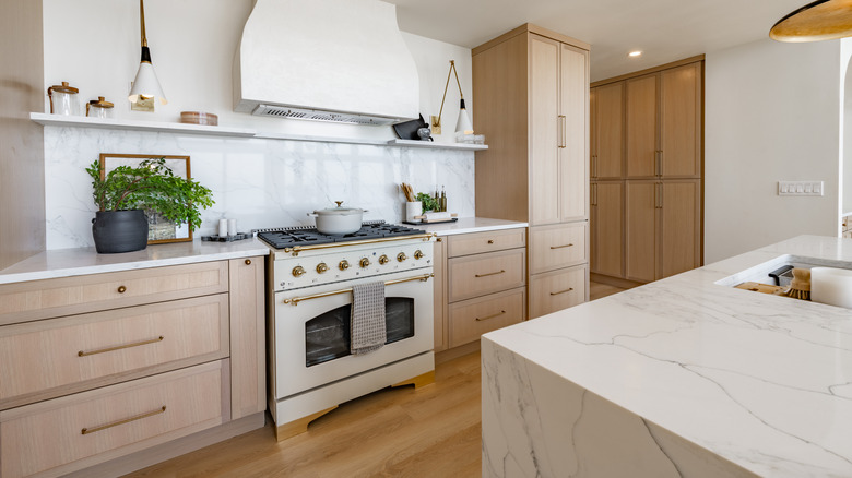 kitchen with beige wood cabinets and marble counters