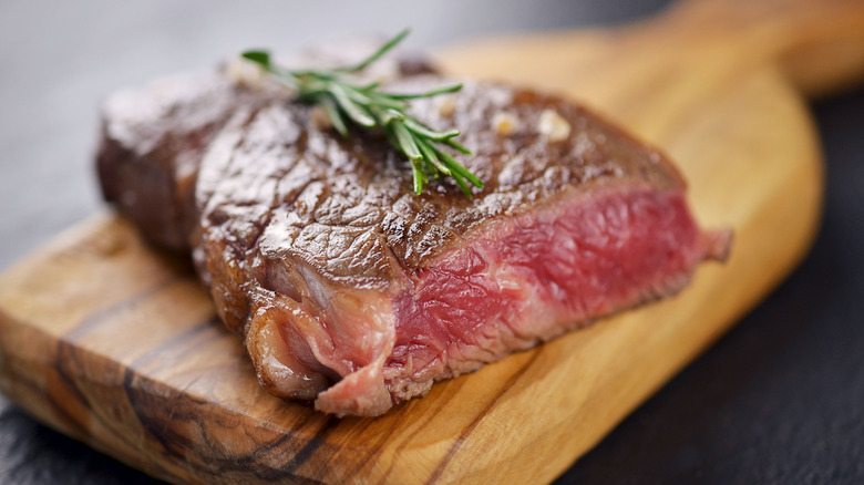Blue rare steak on cutting board