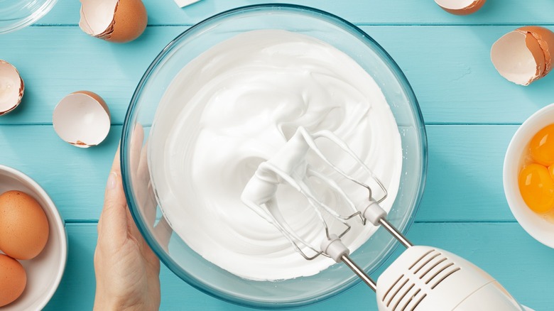 Woman whipping a bowl of meringue
