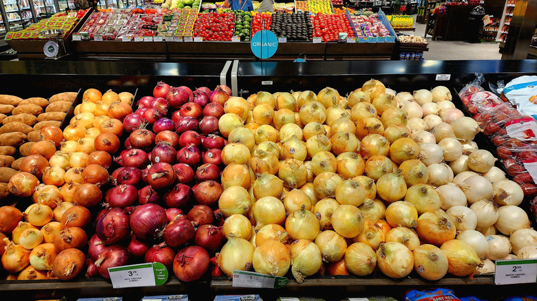 Various varieties of onions in a grocery store