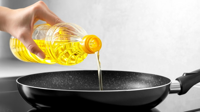 Pouring vegetable oil into pan