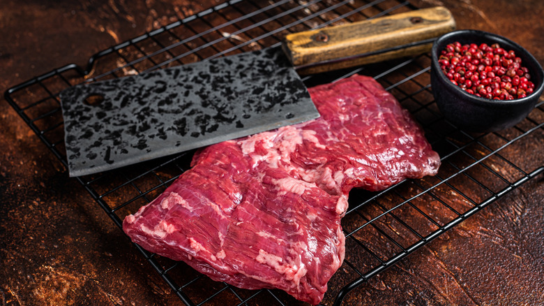 A steak and meat cleaver on a cooling rack
