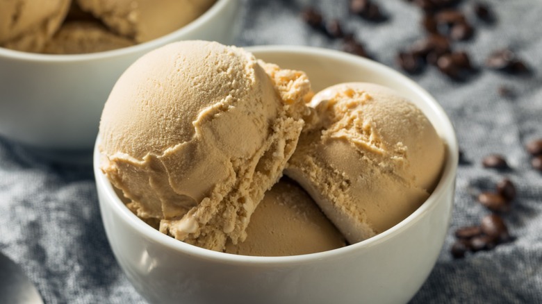 A bowl of coffee ice cream on a marble countertop