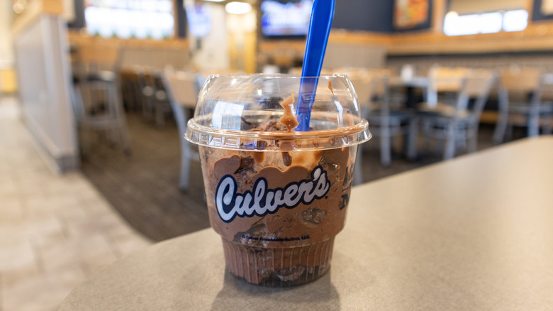 Culver's chocolate custard on a plastic cup with the logo on a restaurant table